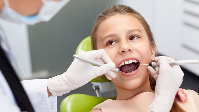 cleaning child's teeth