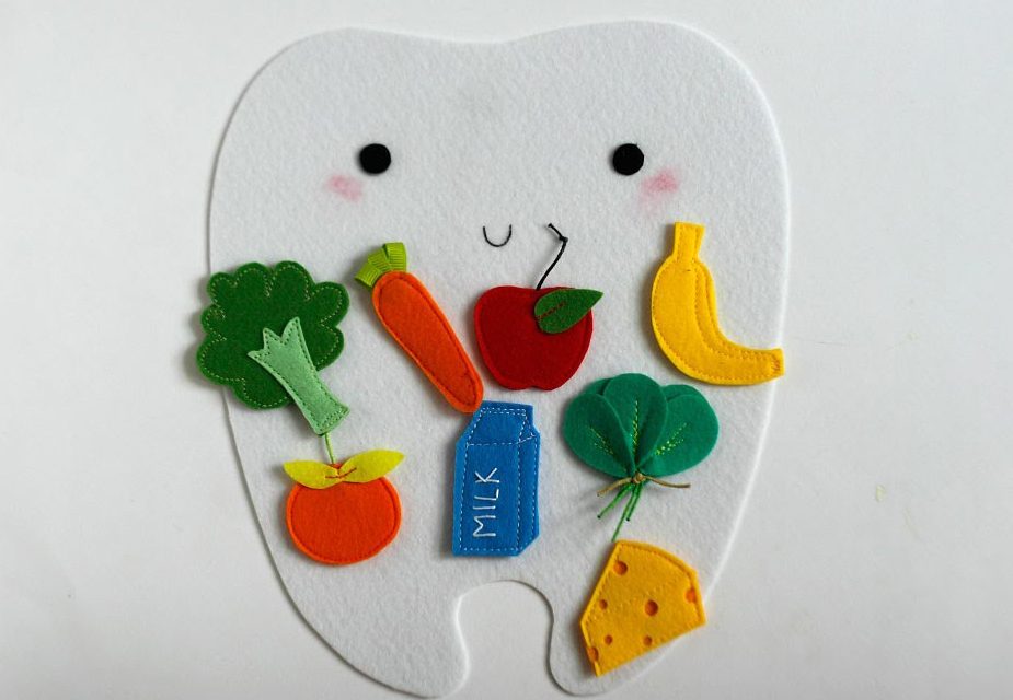 tooth with fruits and vegetables on it