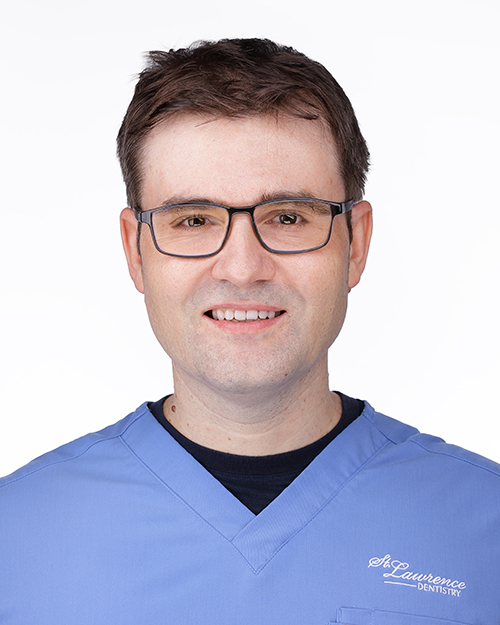 A man with glasses and a blue shirt