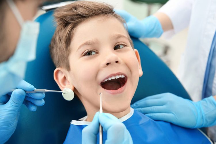 doctor examining a kid's teeth