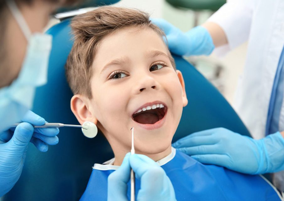 doctor examining a kid's teeth