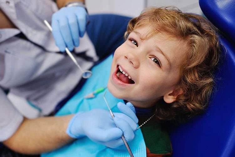 a happy kid in a dental clinic