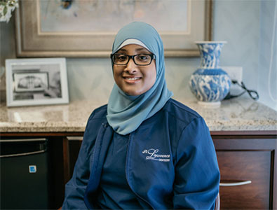 a female doctor wearing hijab and glasses