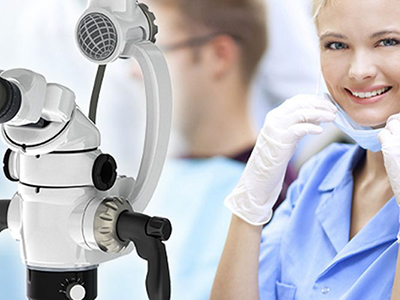 A woman wearing gloves and a facial mask in front of medical apparatus