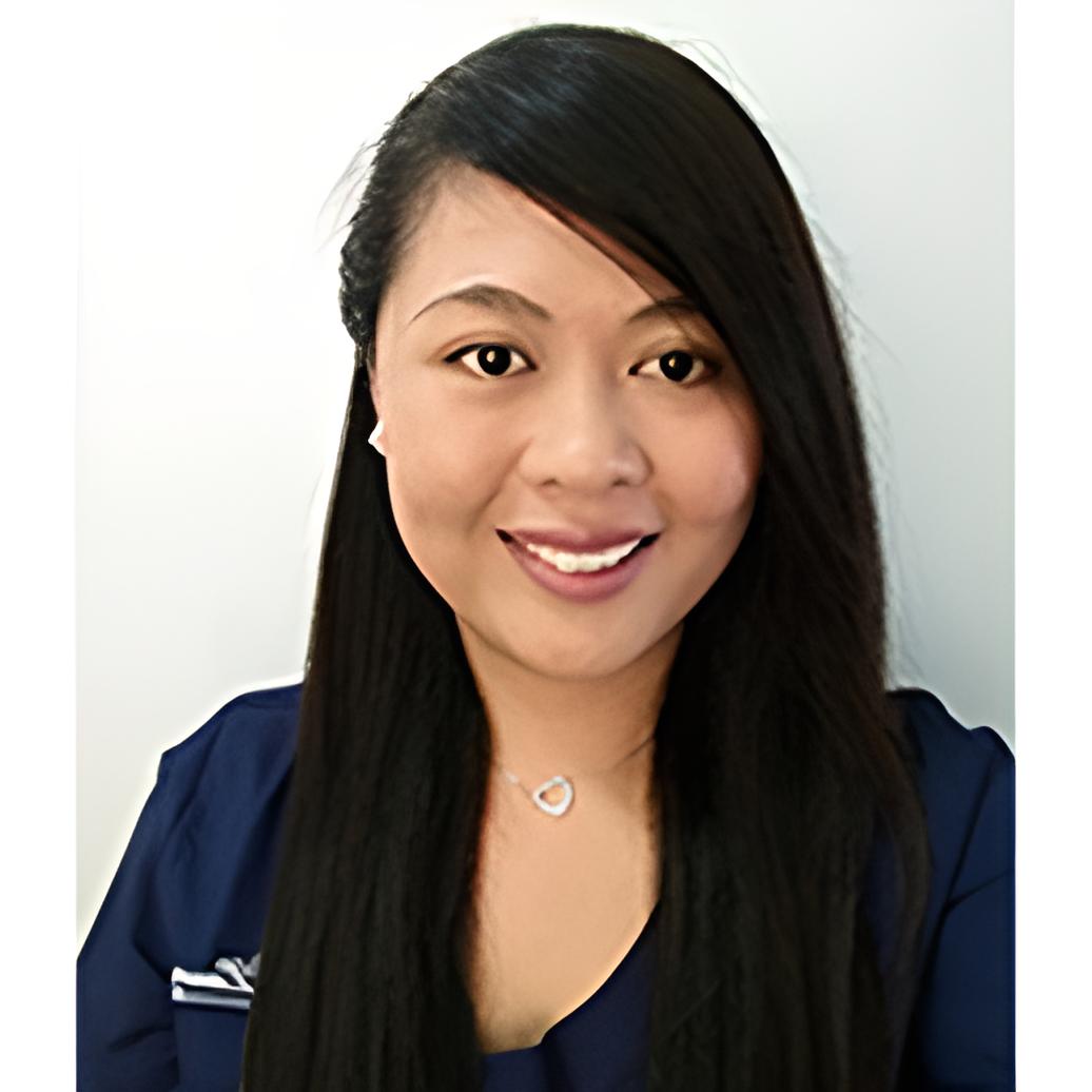 a girl with side bangs wearing a necklace and a blue shirt