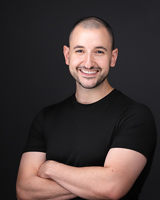 a man with a big smile wearing black t-shirt